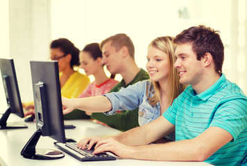smiling students in computer class at school