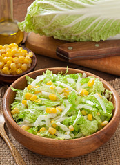 Chinese cabbage salad with sweet corn in a wooden bowl