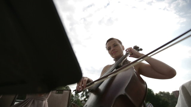 Musical quartet. Three violinists and cellist playing music.