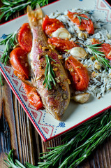 Red mullet baked with tomato, garlic and rosemary with a garnish