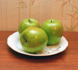 Fresh green apples on plate