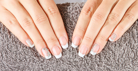 Female soft hands with beautiful french manicure