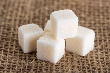 cubes of white sugar on jute bags