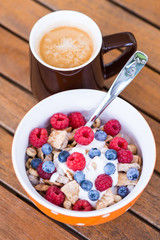 Cornflakes with fresh fruits, yogurt and coffee