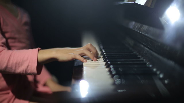 The child learns to play the piano. Video with sound.