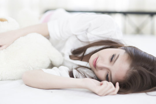 Young woman smile face close up while lying on the bed