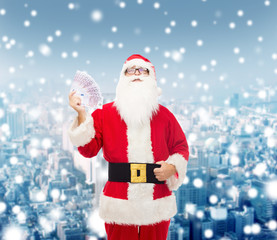 man in costume of santa claus with euro money