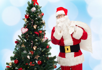 santa claus with bag and christmas tree