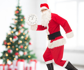 man in costume of santa claus with clock