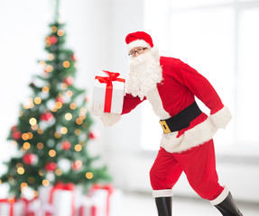 man in costume of santa claus with gift box