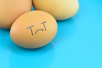 eggs with face  on blue plate for food concept