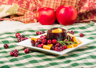 Cranberry sauce on plate with red apples