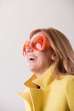happy blonde woman wearing weird sunglasses