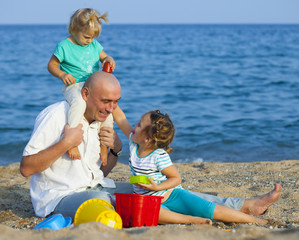 Children with Dad on  beach