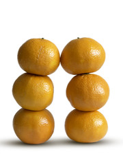 Two stacks of clementines on a white background