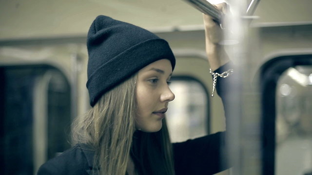 Teen girl rides the metro at night