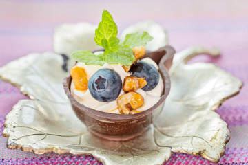 Blueberry and mascarpone dessert in chocolate cups, garnish with