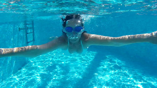 Young Woman Swimming breaststroke