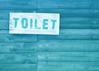 toilet text sign with wood background,blue or cyan color tone