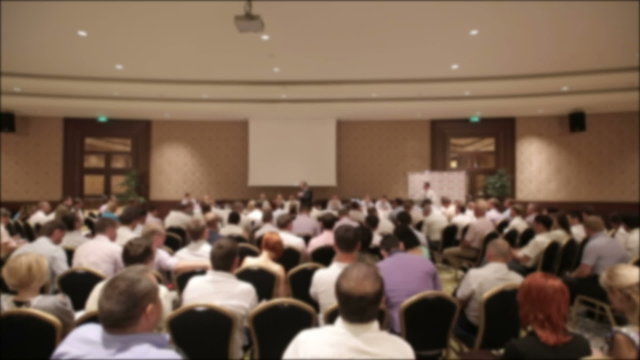 Many people at a conference or seminar. Blurred background