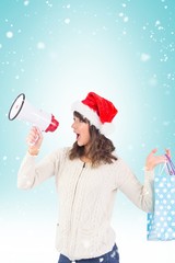 Composite image of festive brunette holding megaphone and bags