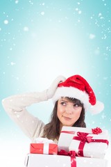 Composite image of santa woman scratching head and holding gifts