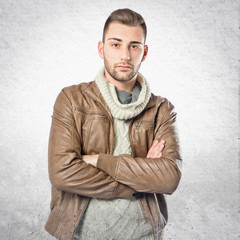 Handsome man with arms crossed over isolated background