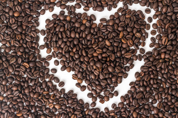 white heart silhouette on a coffee bean
