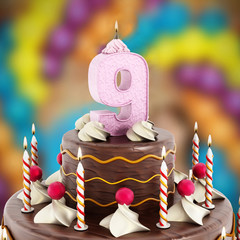 Birthday cake with number 9 lit candle