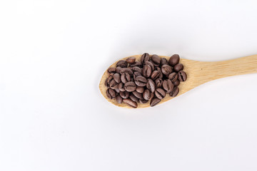 wooden spoon full of coffee beans