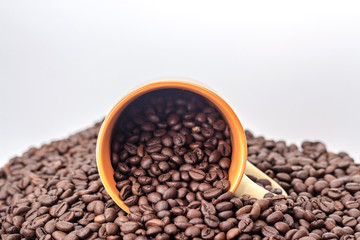 orange cup with coffee beans