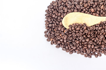 Scoop on the background of a heap of coffee beans