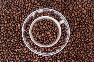 Cup and saucer with coffee beans