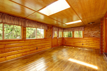 Bright empty log cabin house interior with skylights