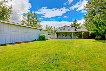 Fototapeta premium Large countryside house exterior with backyard land