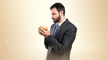 Young businessman drinking a coffee over white background