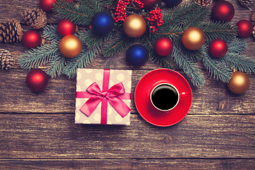 Hot coffee on a table near pine branches with chritmas balls
