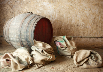 Old barrel with burlap sacks.
