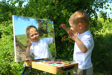 funny kid draws a picture on the mirror - 74183510