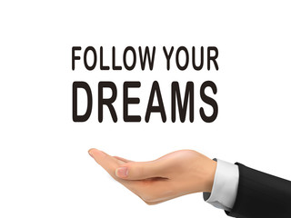 follow your dreams words holding by realistic hand