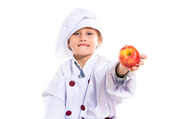 Blonde little girl dressed like chef holding an apple
