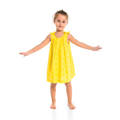 Blonde little girl dancing over white background