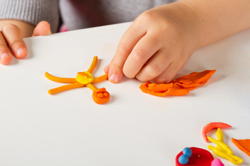 Child hands  with colorful clay