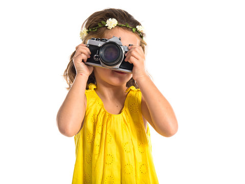 Blonde little girl photographing something