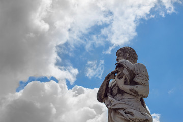Statue and clouds