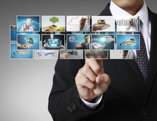 Man pushing on a touch screen digital photos