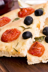 Focaccia with black olives, tomatoes and basil