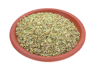 Savory herb in a small bowl on a white background
