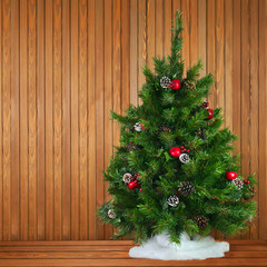 Green Decorated Christmas Tree on Wooden Background.