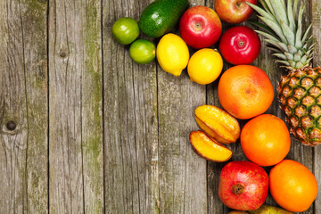 Fototapeta na wymiar Set of colorful fruits on old wood background
